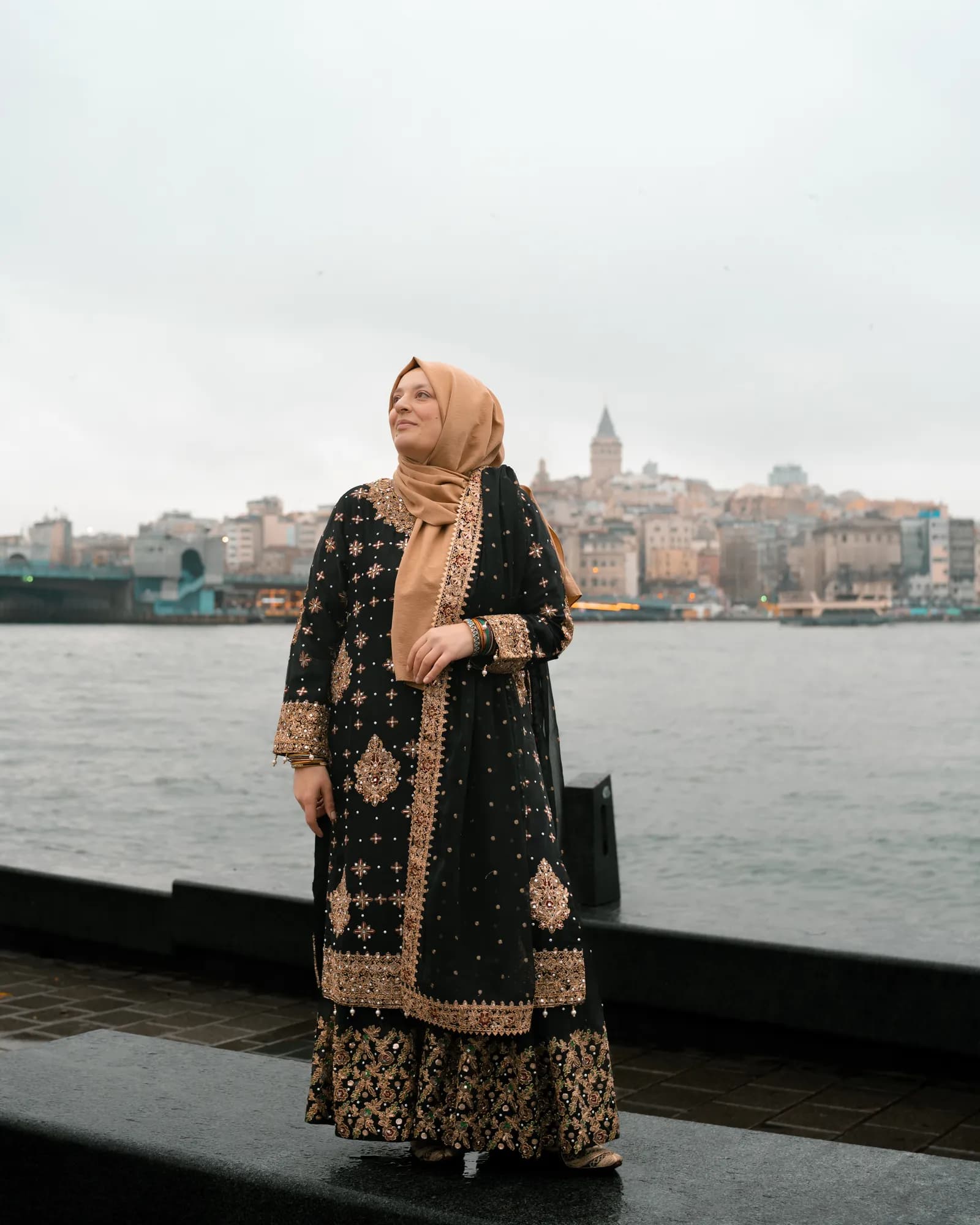 Türkan Atay on the Golden Horn waterfront, with Galata Tower on the skyline behind her
