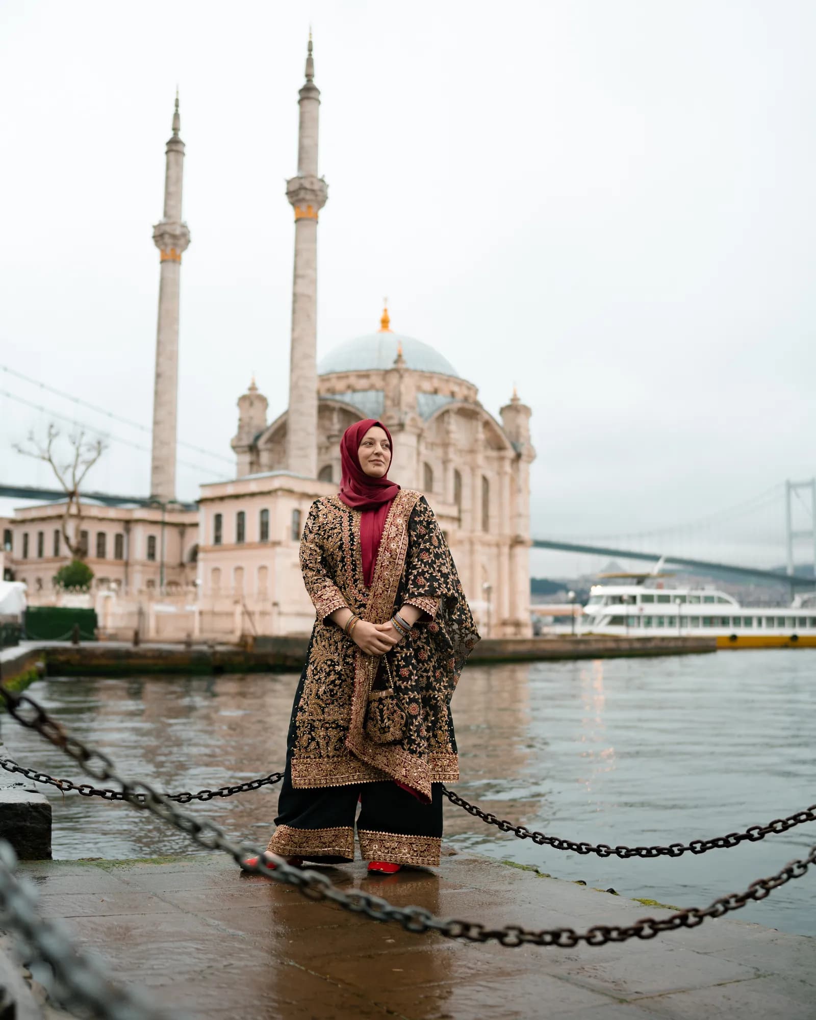 Türkan Atay on the Ortaköy waterfront, with Ortaköy Mosque and the Bosphorus Bridge behind her