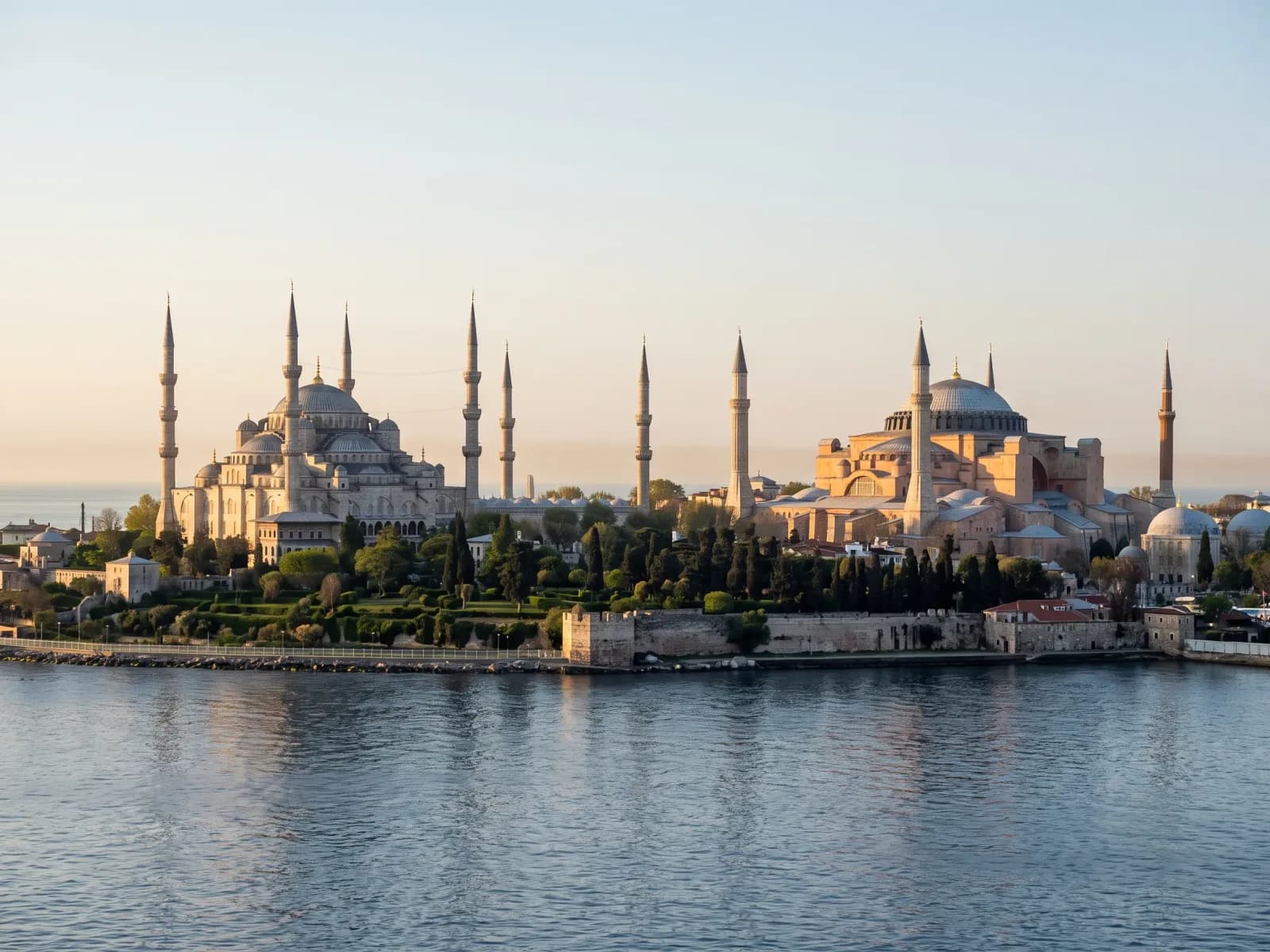 The Blue Mosque and Hagia Sophia on the Istanbul Old City skyline, seen from the water at golden hour